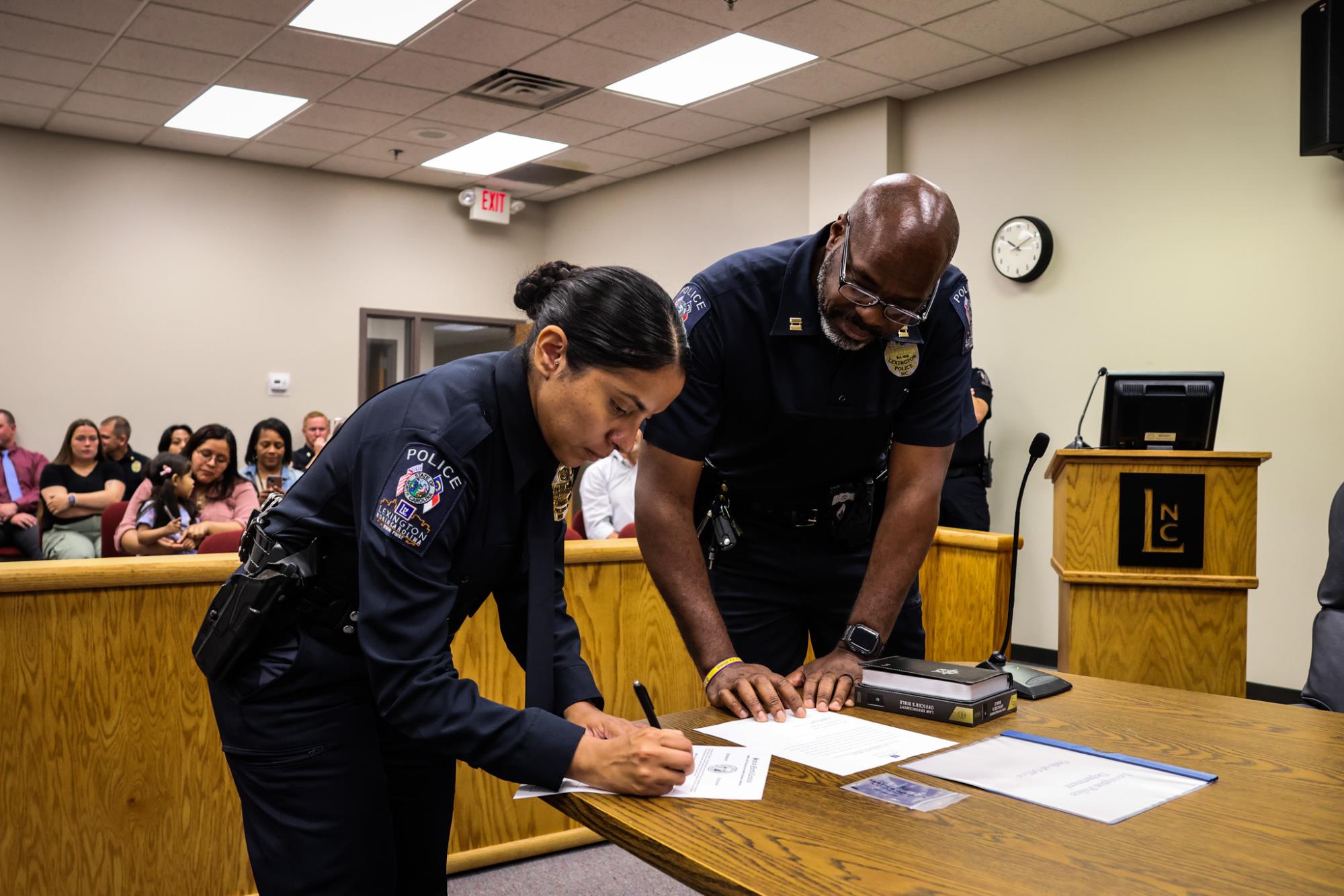 Hispanic female police officer being sworn in as a Lexington Police Department officer